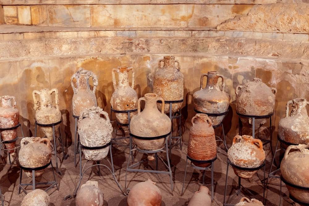 Collection of antique ancient clay jars, pots and bottles. Exhibition in an archeology museum.